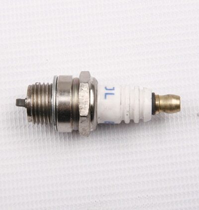 A Spark Plug for 2-stroke Engine (SP-1) (LCJ-D016) on a surface.