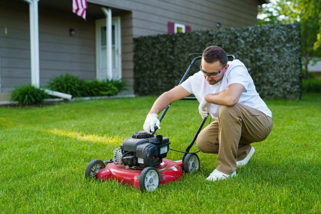 A man working on a lawn mower.